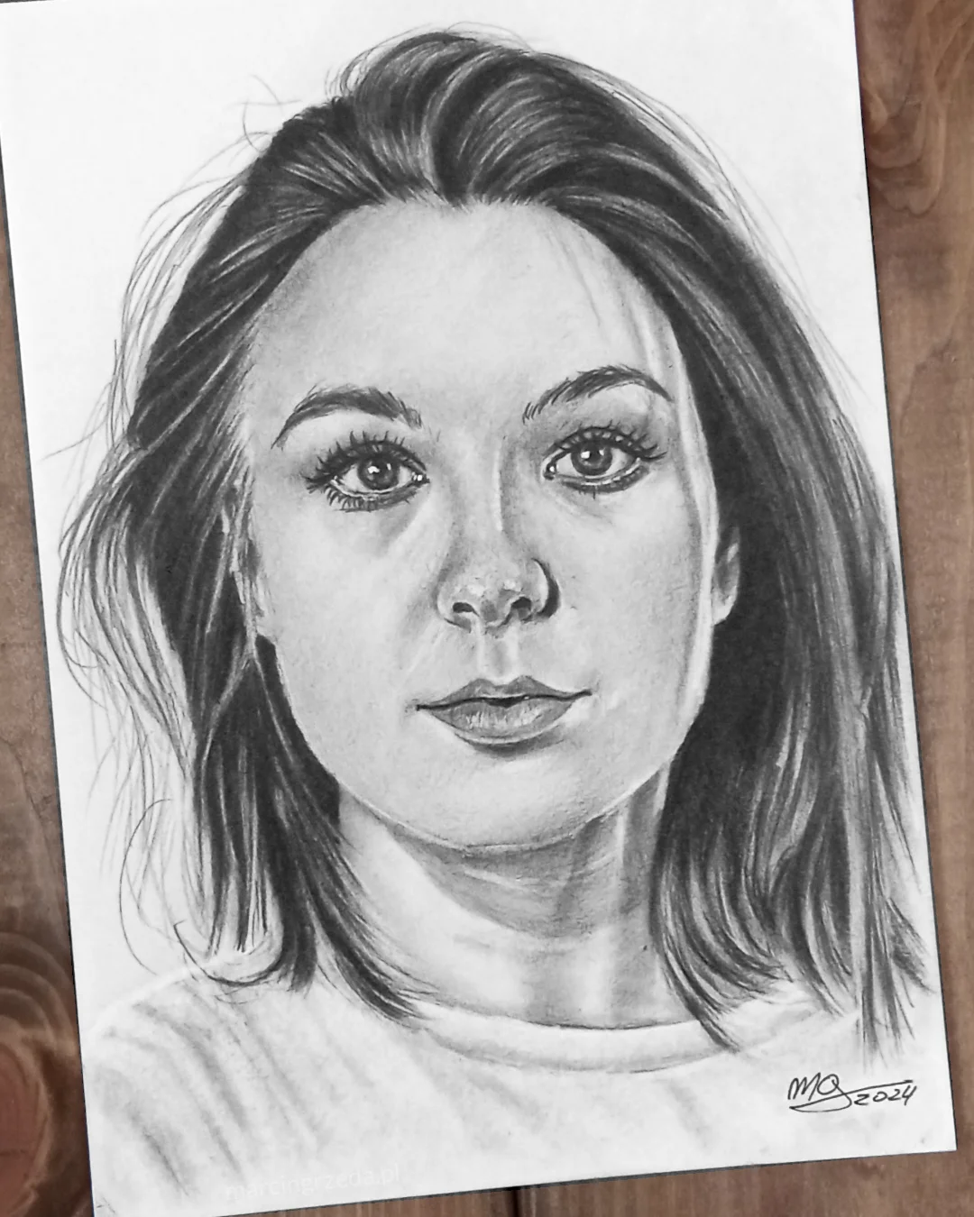 Portret dziewczyny z ciemnymi włosami wykonany ołówkiem.